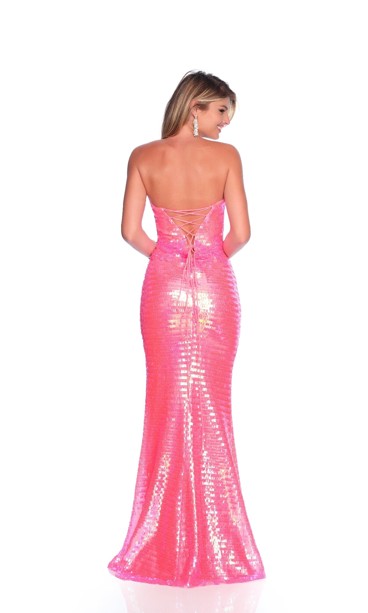A woman models the Hot Pink Prom Dress: Dave & Johnny 11927, a strapless sequin gown with a lace-up back, standing against a white background.